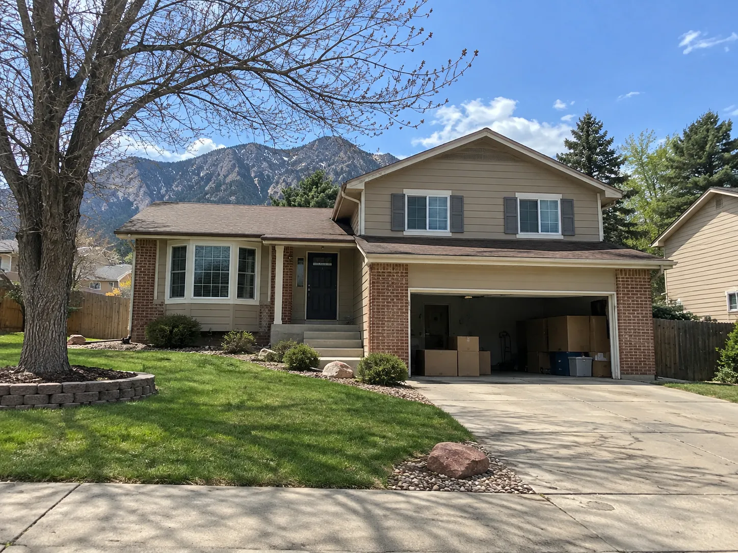 Colorado Springs house with moving boxes and normal exterior maintenance needs